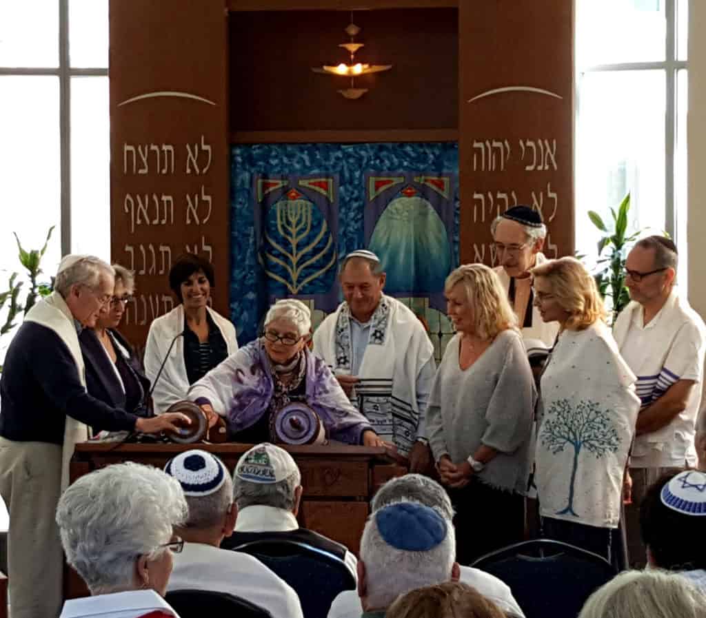 Minyan members gather to read from the Torah.