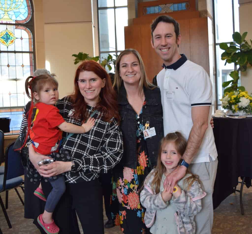 A family poses at a member event