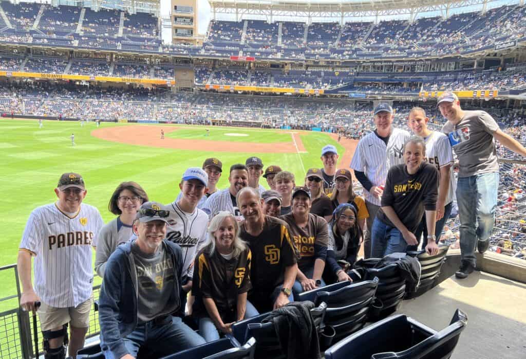 A group of Beth Israel members gather for a picture with the Petco Park field in the background at the San Diego Padres game.