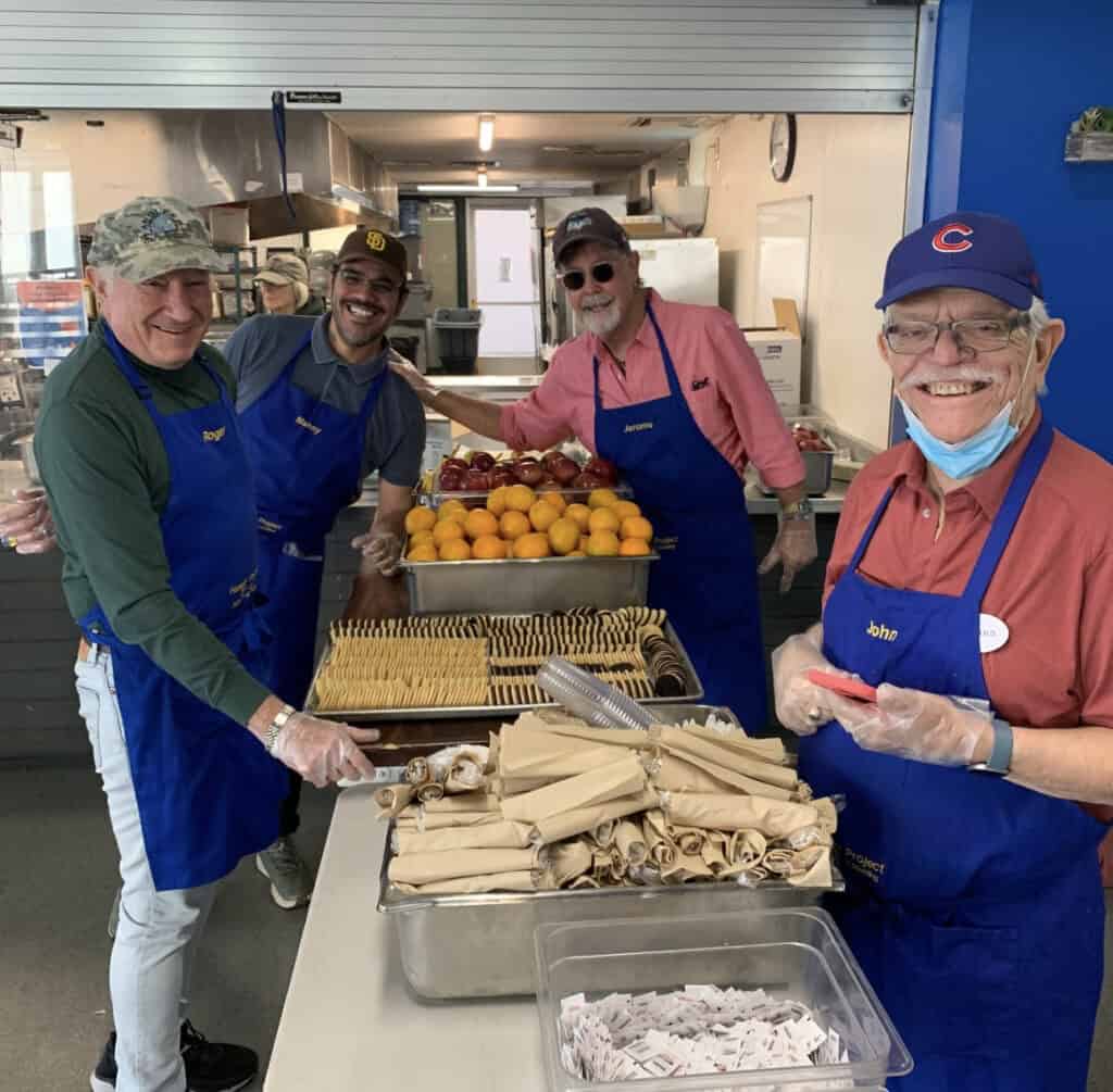 Men's Club members work on preparing food for the Hunger Project