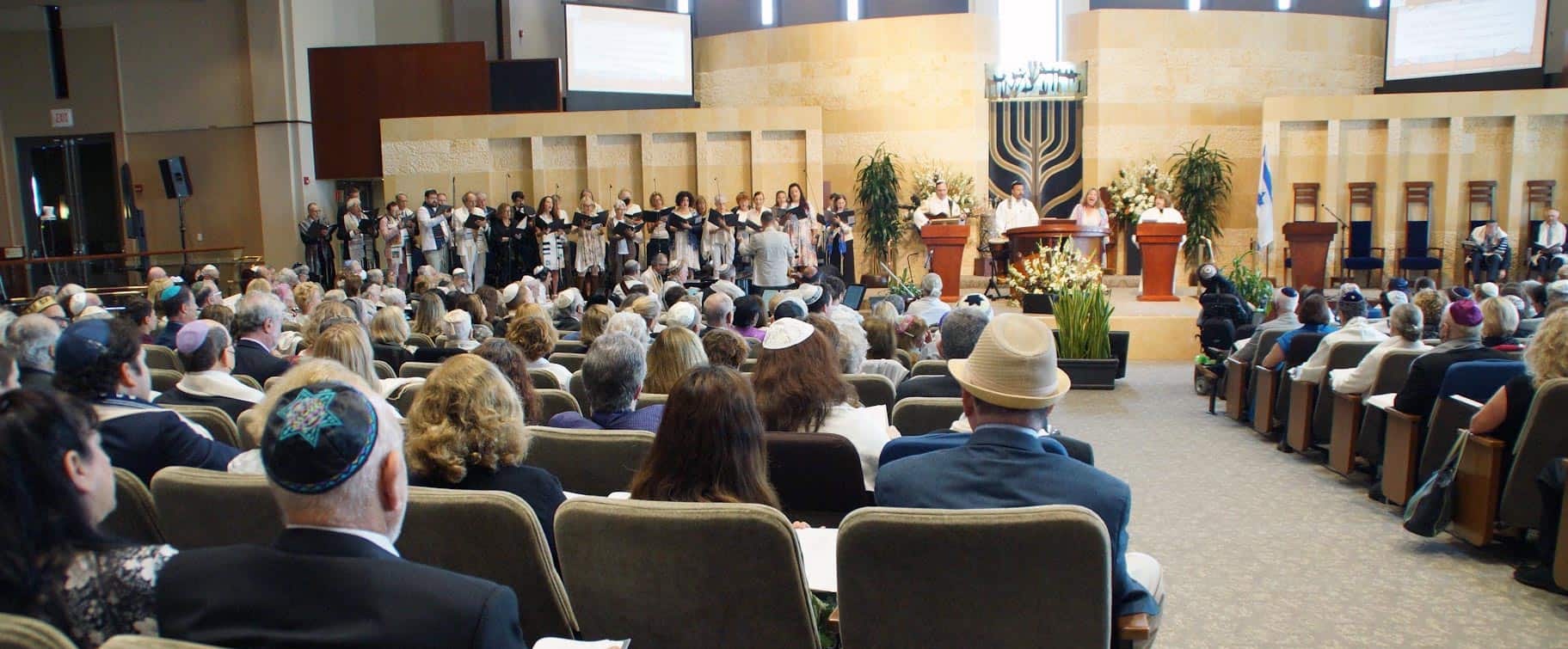 People seated in a synagogue during a High Holy Day service