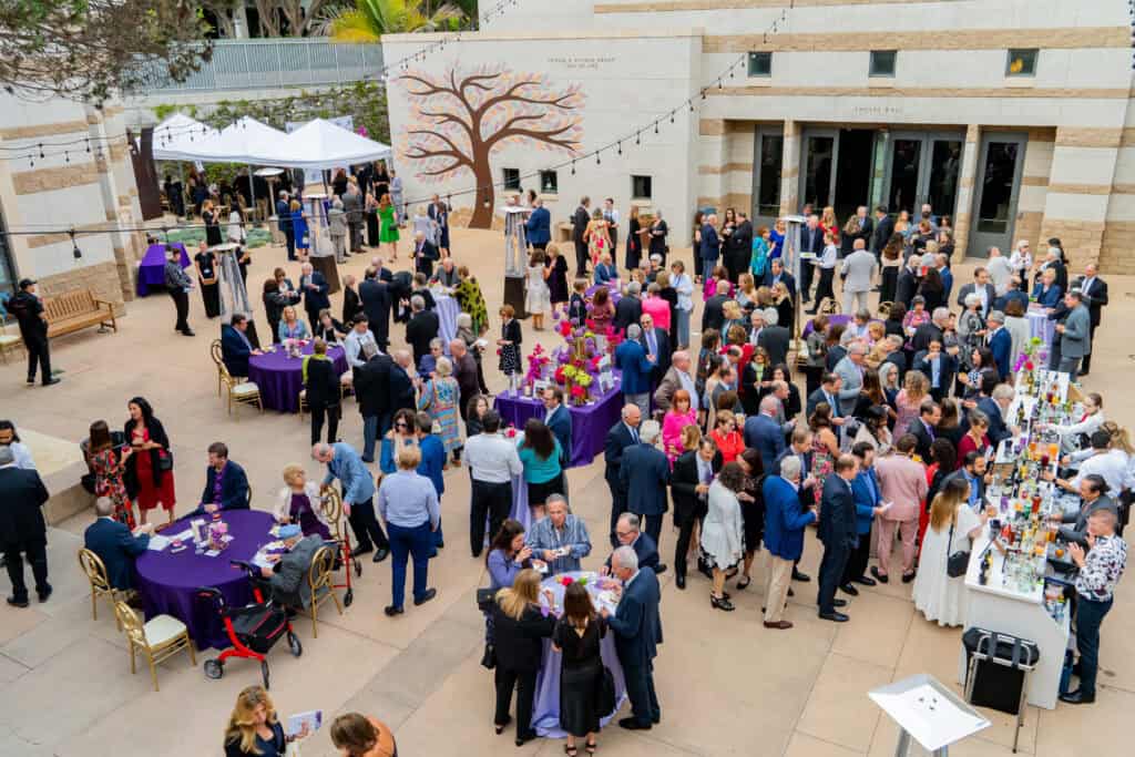 Guest gather in the CBI courtyard for cocktail hour during the 2024 Gala.
