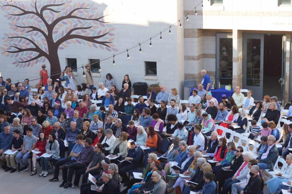 Members of the congregation attend an outdoor service in the CBI courtyard