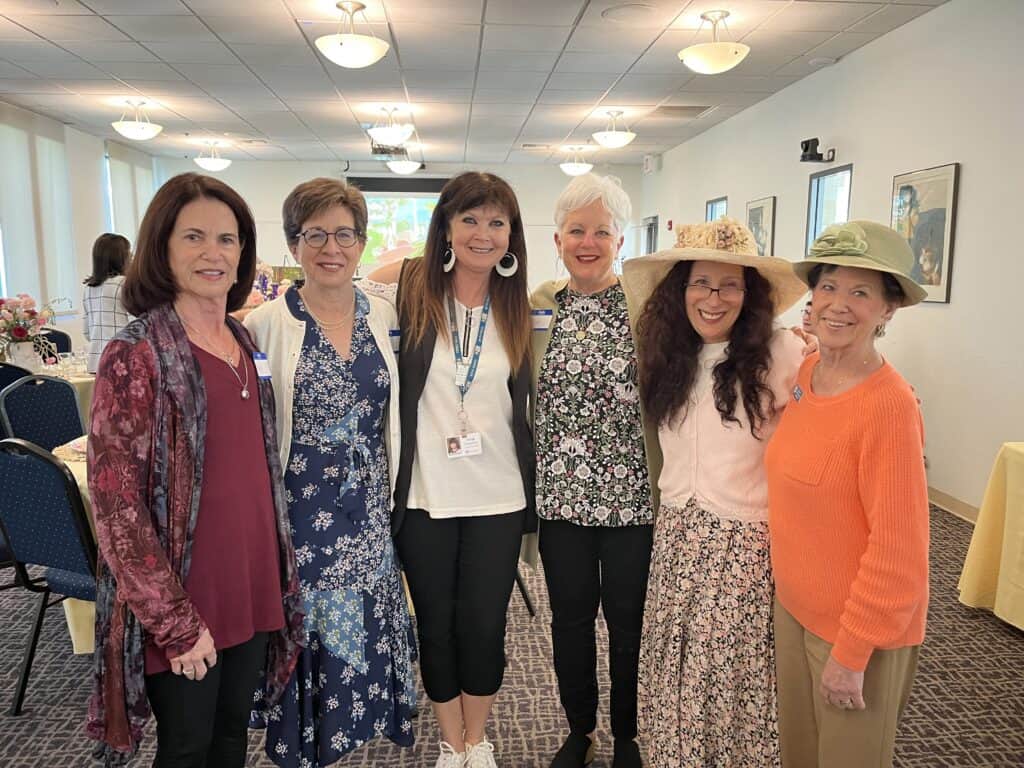 A group of women stand together at an event hosted by Women of Beth Israel.