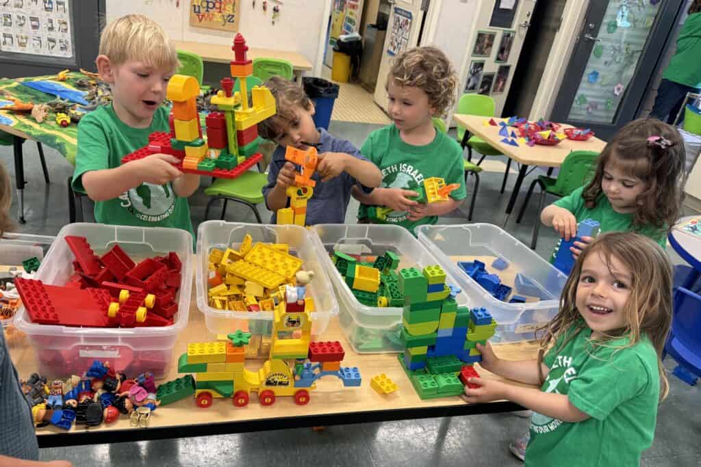 Campers build with legos inside a classroom.