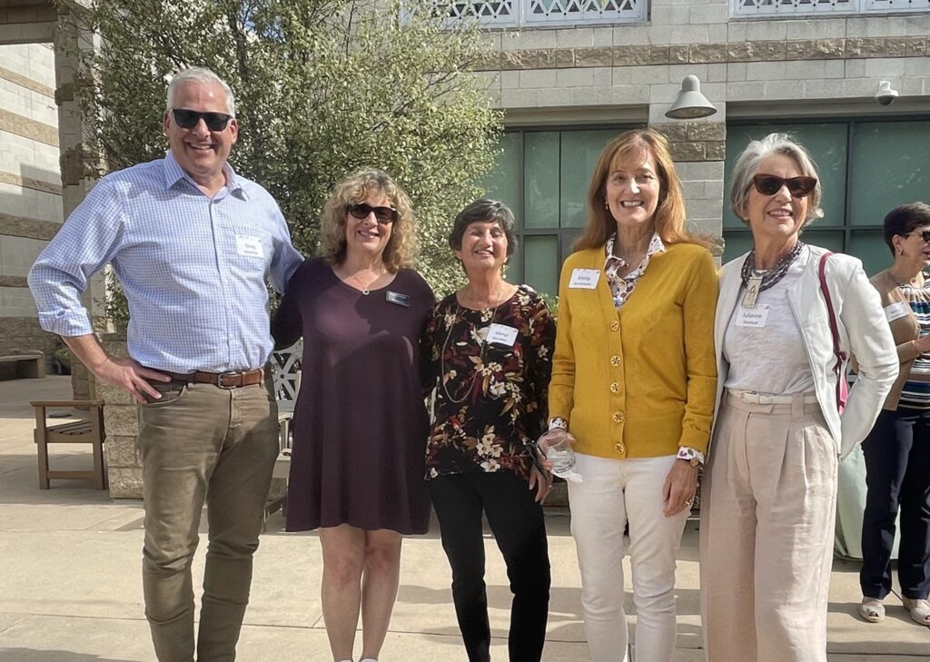 Five congregants pose at an event in the CBI courtyard