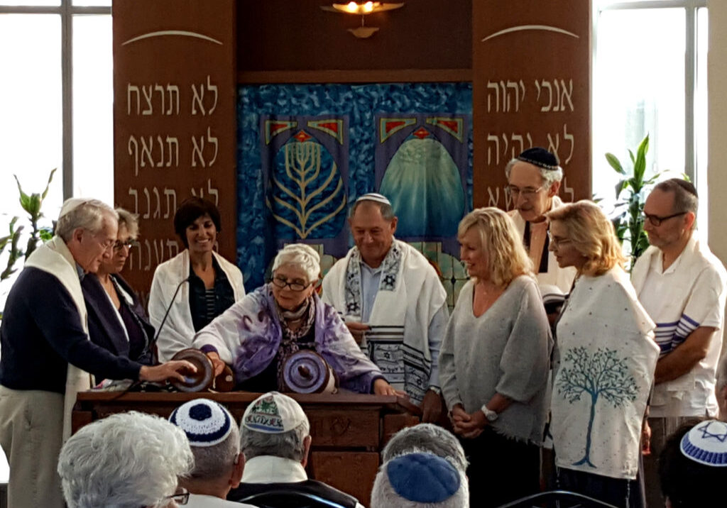 Minyan members gather to read from the Torah.
